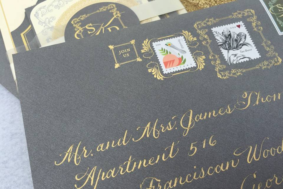 Gold lettering to match the gold foil decoration on the envelopes.