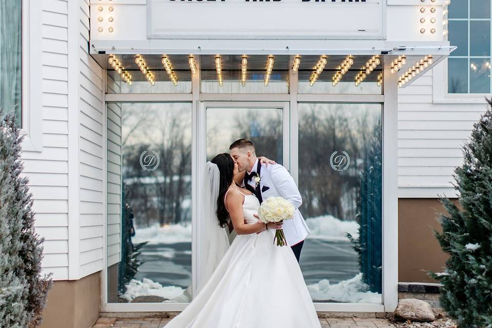 Kiss by the retro marquee