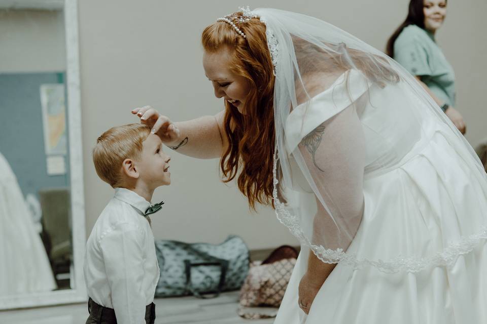 Bride fixing ring bearer hair