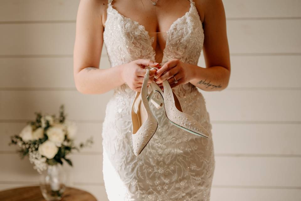 Bride holding sparkly shoes