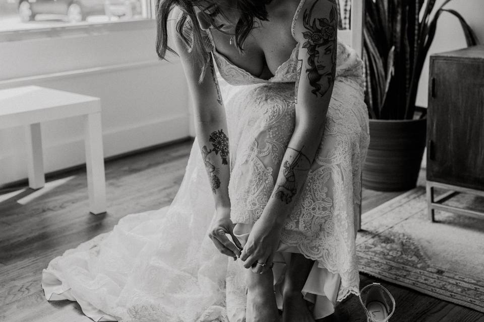 A bride puts on her shoes