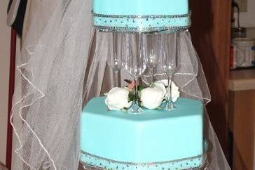 Dummy cake with fondant and ribbon and a real bridal veil with head piece.
