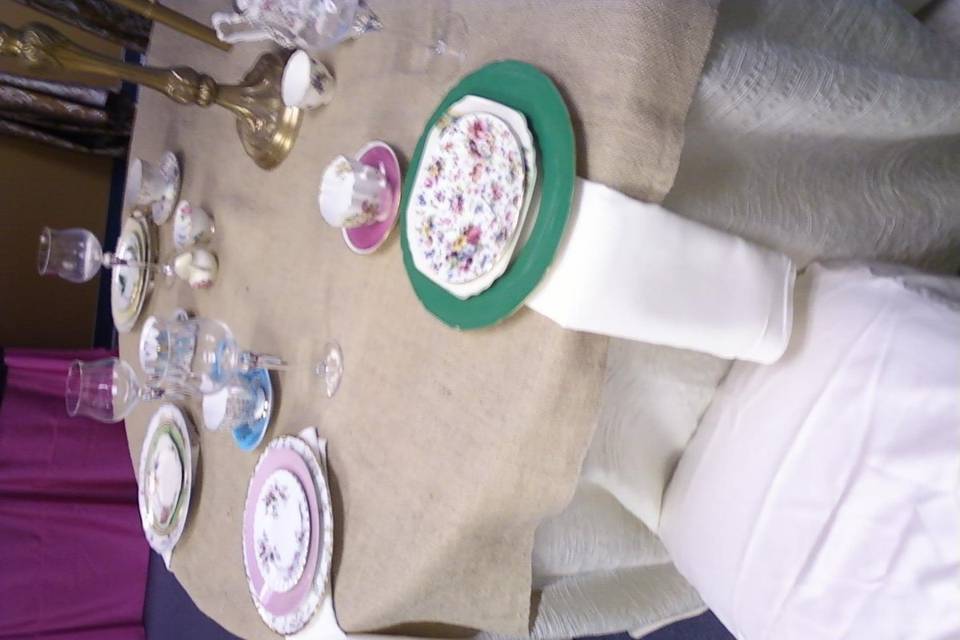 Display at LinenHero Atlanta of Vintage Mismatched Fine China on Soft Burlap Linen