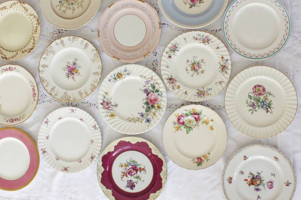 Some of our 300 Dinner Plates laying on a lace cloth.