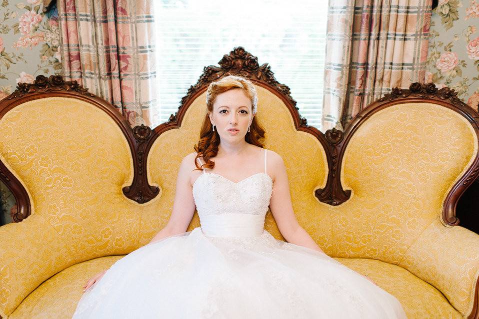 Our fabulous Bride Micah seated on victorian settee at the Whitlock Inn in Marietta