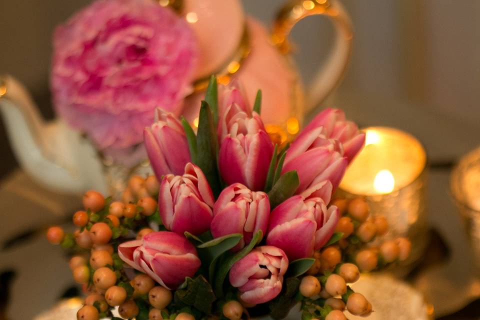 Teapot and cake plate decorated with gorgeous flowers make a delicate display on side tables