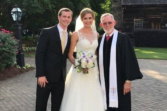 Bride, groom, and the reverend
