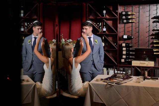 The bride fixes the groom.