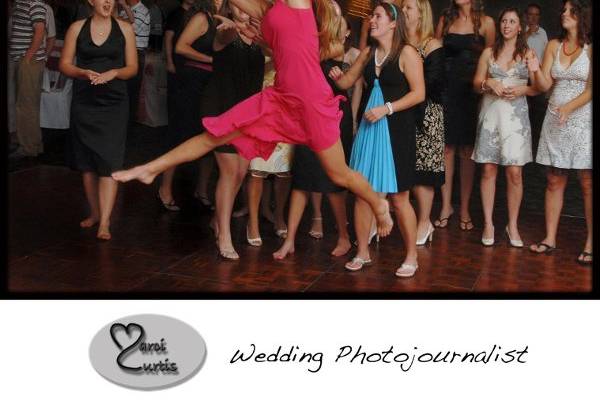 Bridesmaid leaps for the bouquet during a ballroom wedding reception.