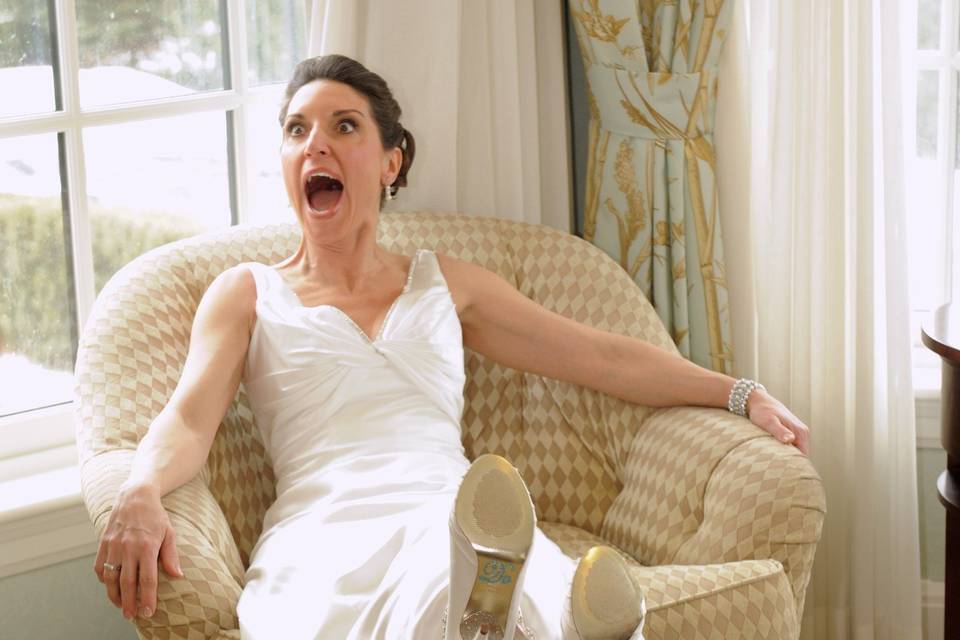 The bride shows off her shoes, but when told if she crosses her feet it says, 