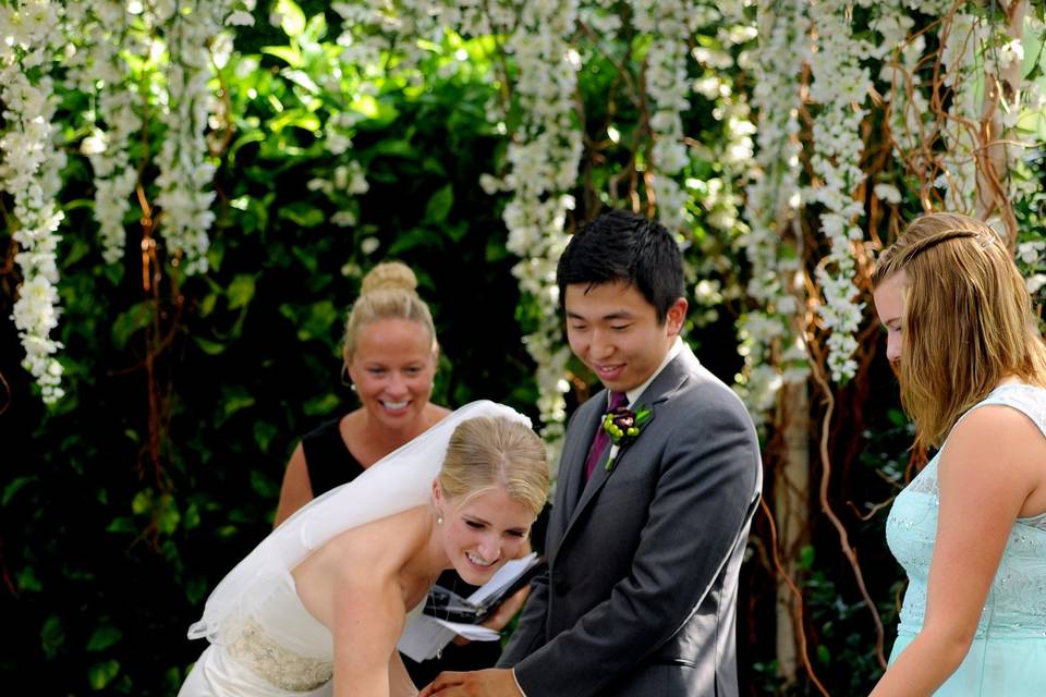 The bride high fives her dog during her Planterra wedding in Bloomfield, Michigan.