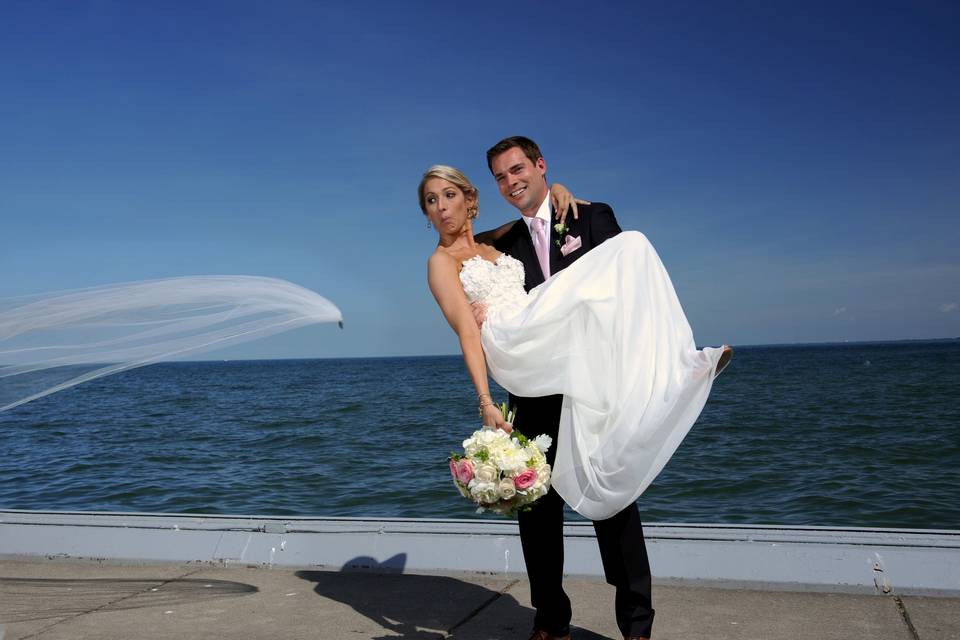 The bride notices her veil falling off in the wind after her Grosse Pointe, Michigan wedding.