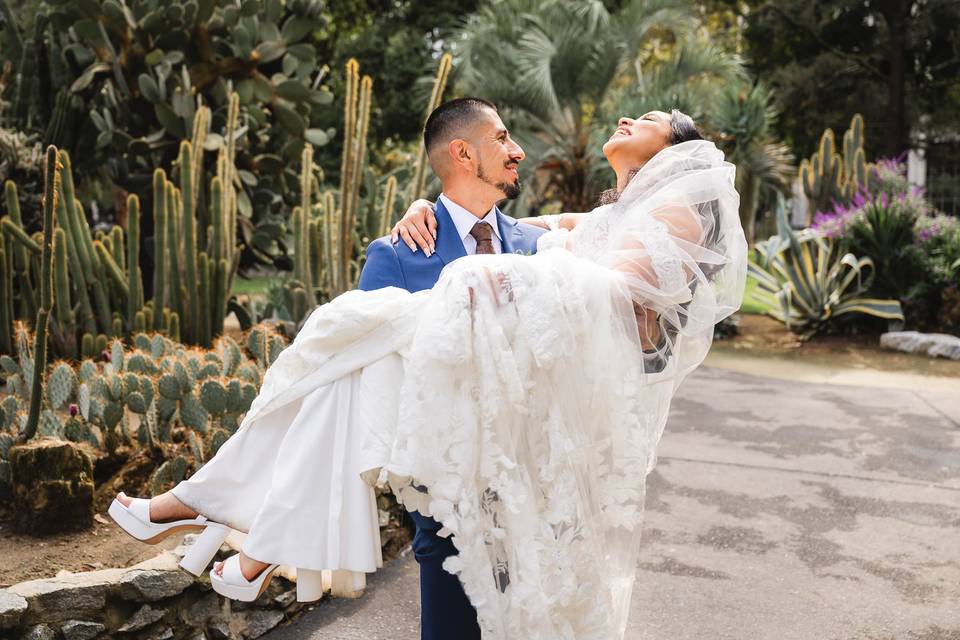 A groom holds his bride aloft