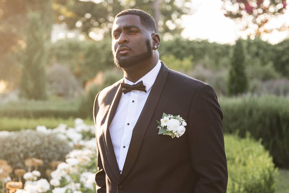 A groom waits in the garden