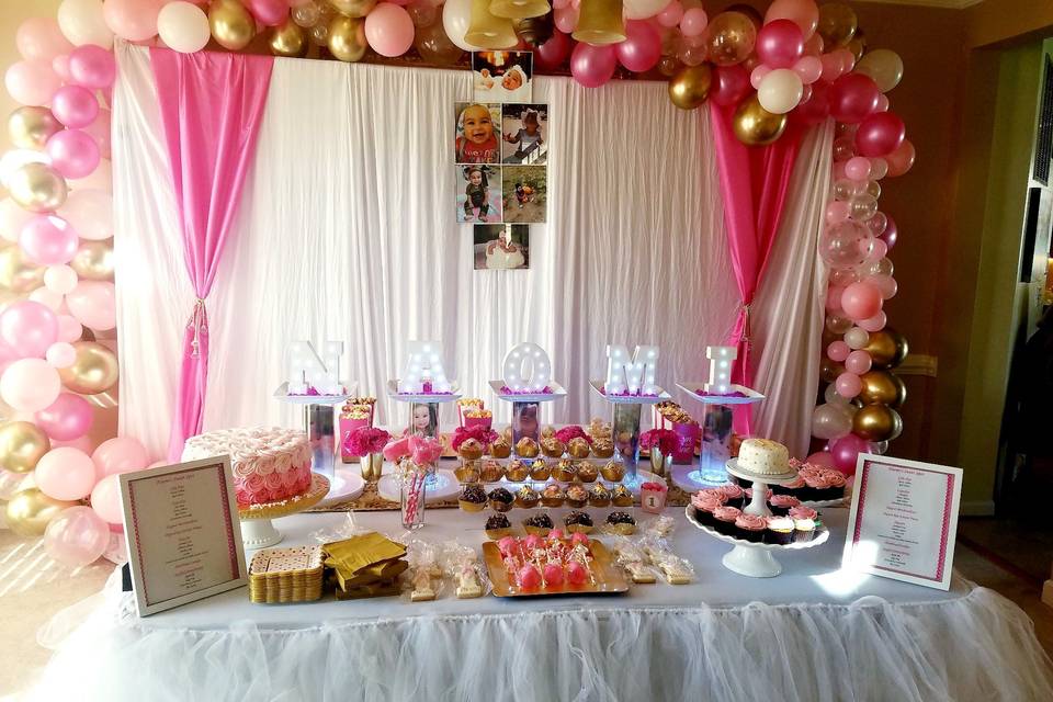 Pink balloons and dessert table