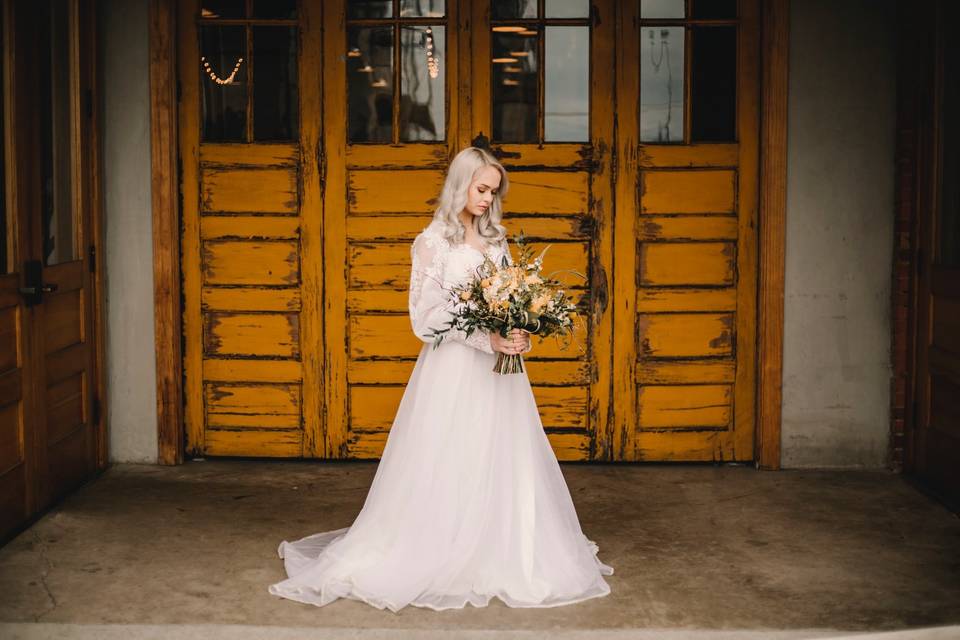 Bride in front of yellow door