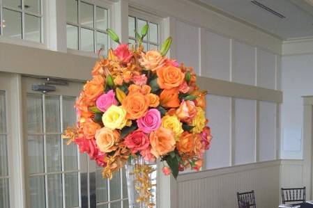 A tall pisner vase with orange, pink and yellow roses.
All I have to say is WOW
