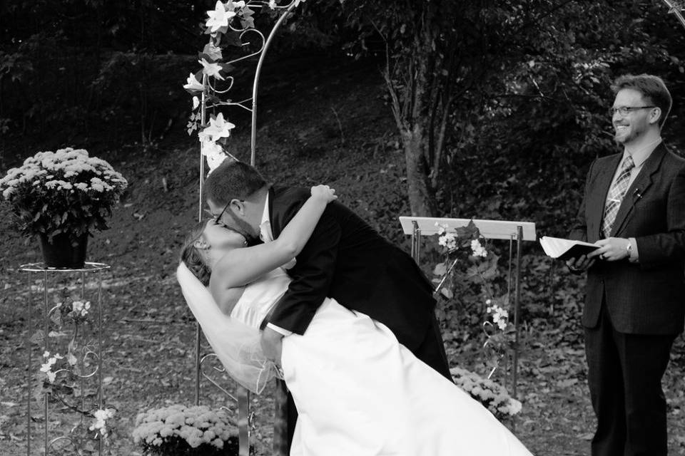 Groom dips his bride for a kiss