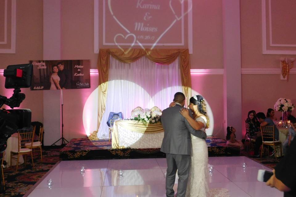 First dance as husband and wife with monogram in the background