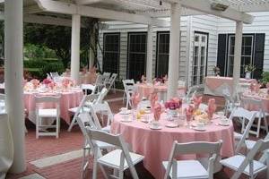 A lovely ceremony or reception setting featuring our lush landscaping, fountain grotto and our charming patio shaded by a wisteria covered patio.