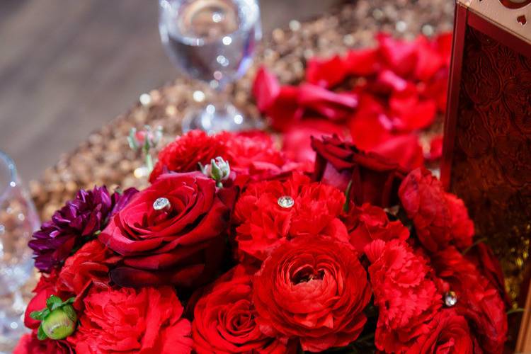 Big red bouquet made with red roses, red carnations, red ranunculus.