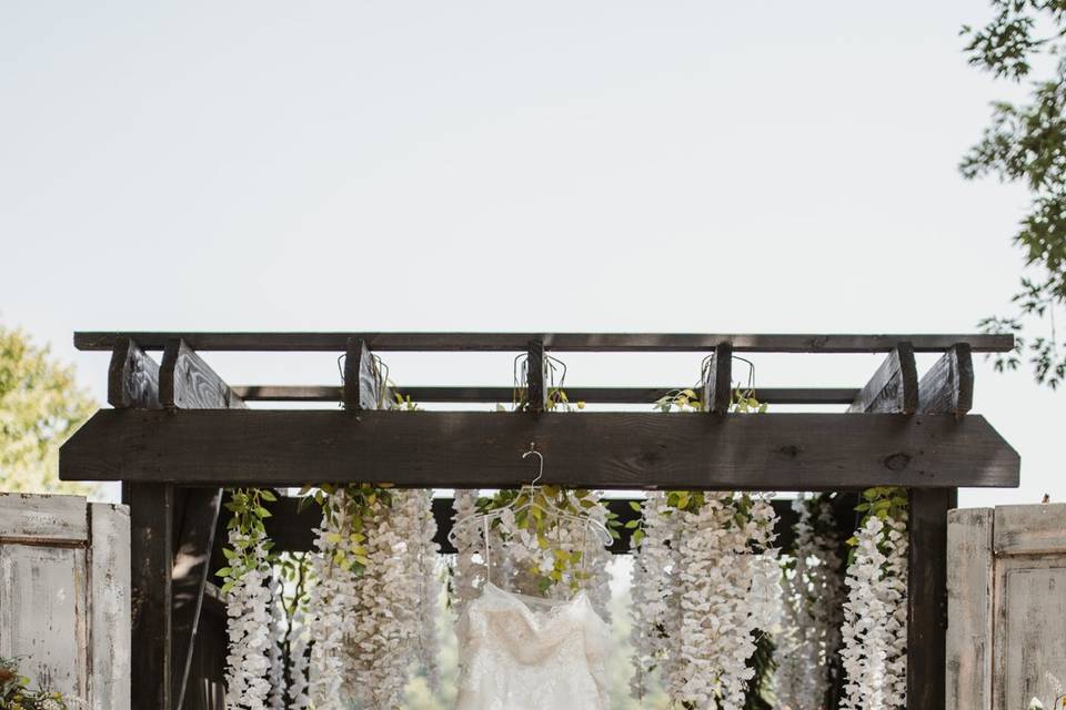 Wedding dress hanging on arch