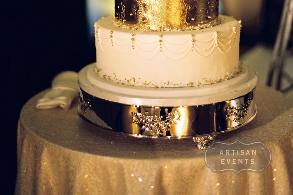 Three tier white and gold wedding cake