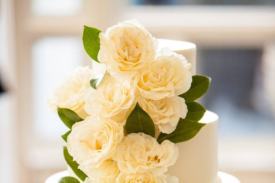 Three tier wedding cake with white roses
