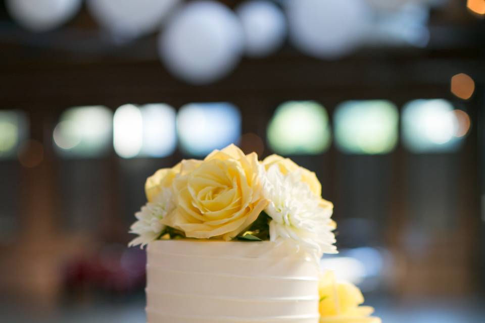 Three tier wedding cake with yellow flowers