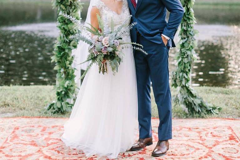 Kissing by the wedding arch