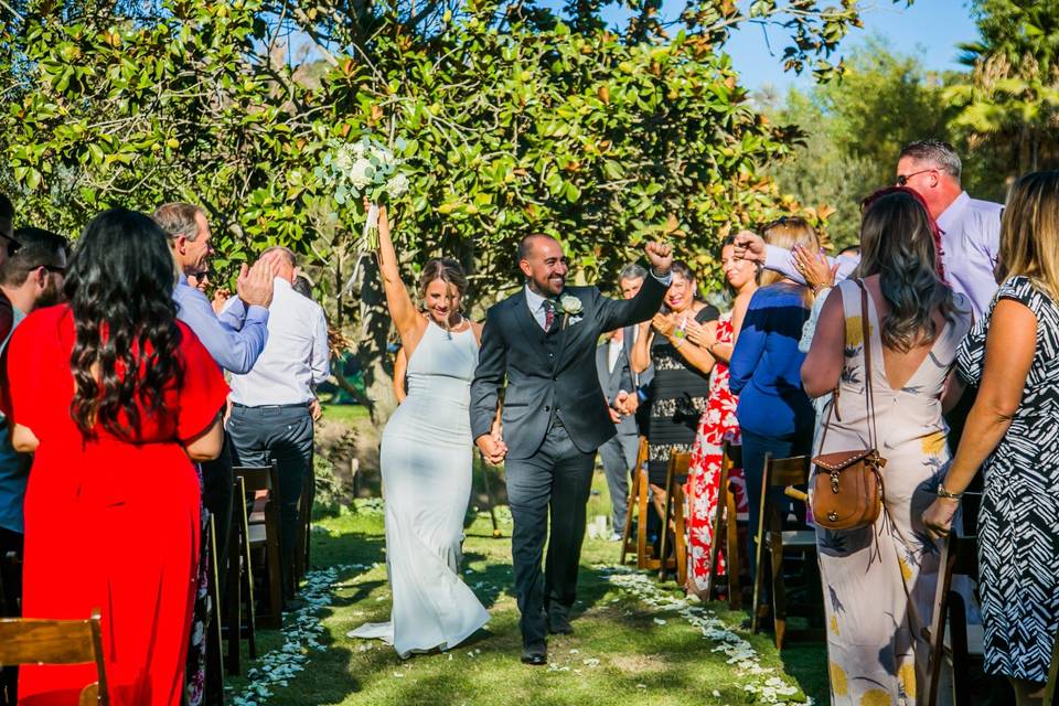 Newlyweds walking down aisle