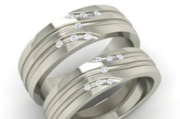 This contemporary wedding band set has a sleek design with delicately set diamonds in metal. These matching wedding bands can be requested in other color diamonds / gemstones and different widths.