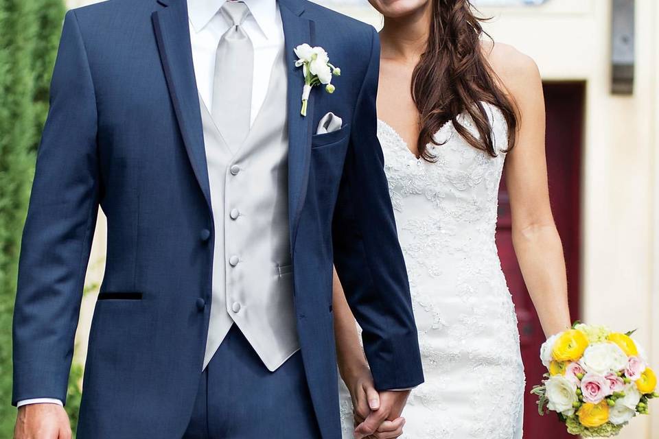 Navy suit and white wedding dress of newlyweds