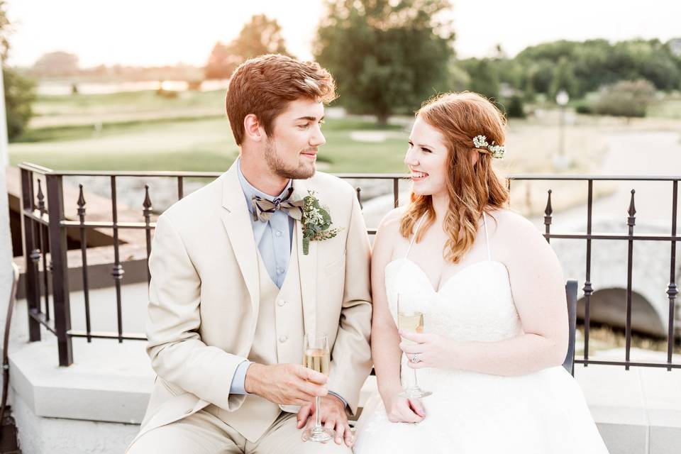 Newlyweds sitting by the rails