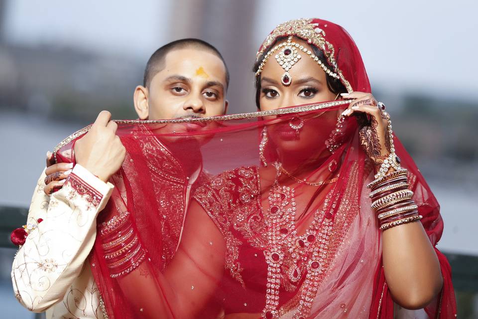 Couple hide behind the bride's veil