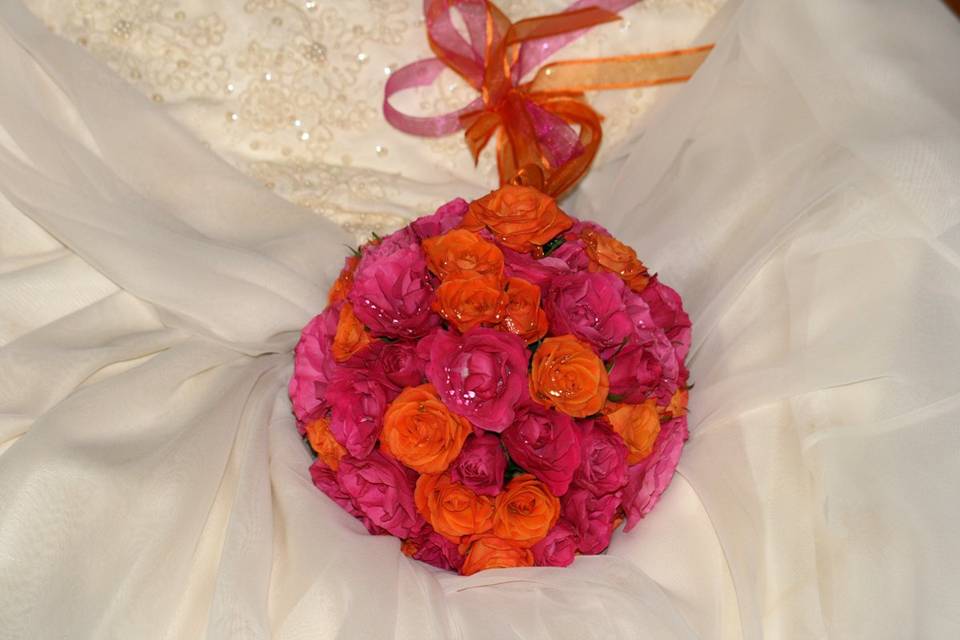 contemporary pomander with orange and deep pink  mini roses