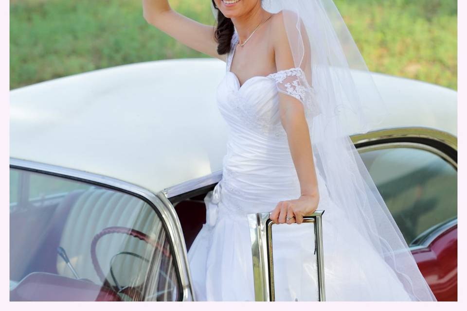 Bride posing with car