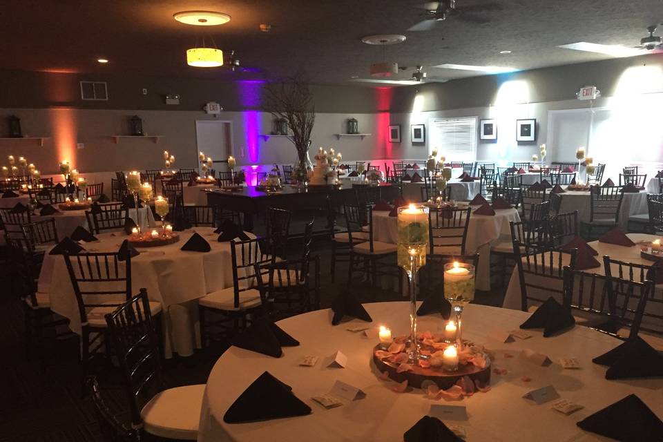 Candlelit tables and reception uplights