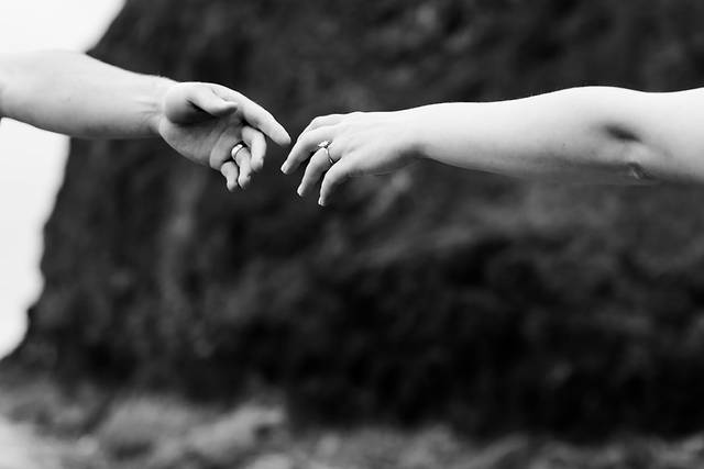 Black and white hands reaching