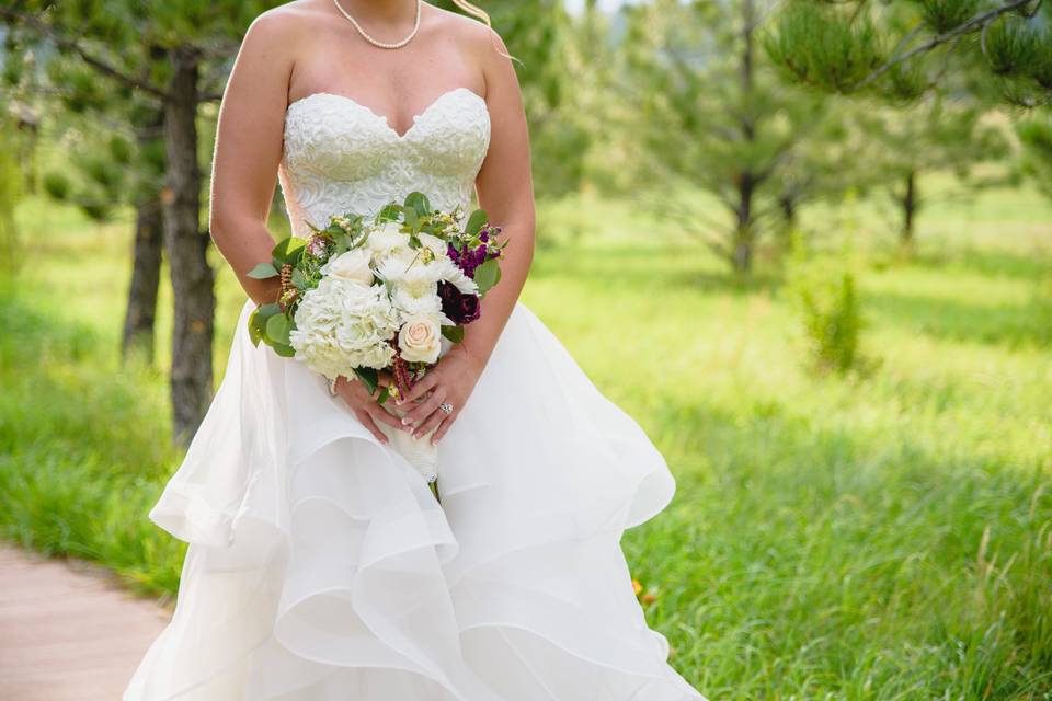 The bride holding a bouquet of roses