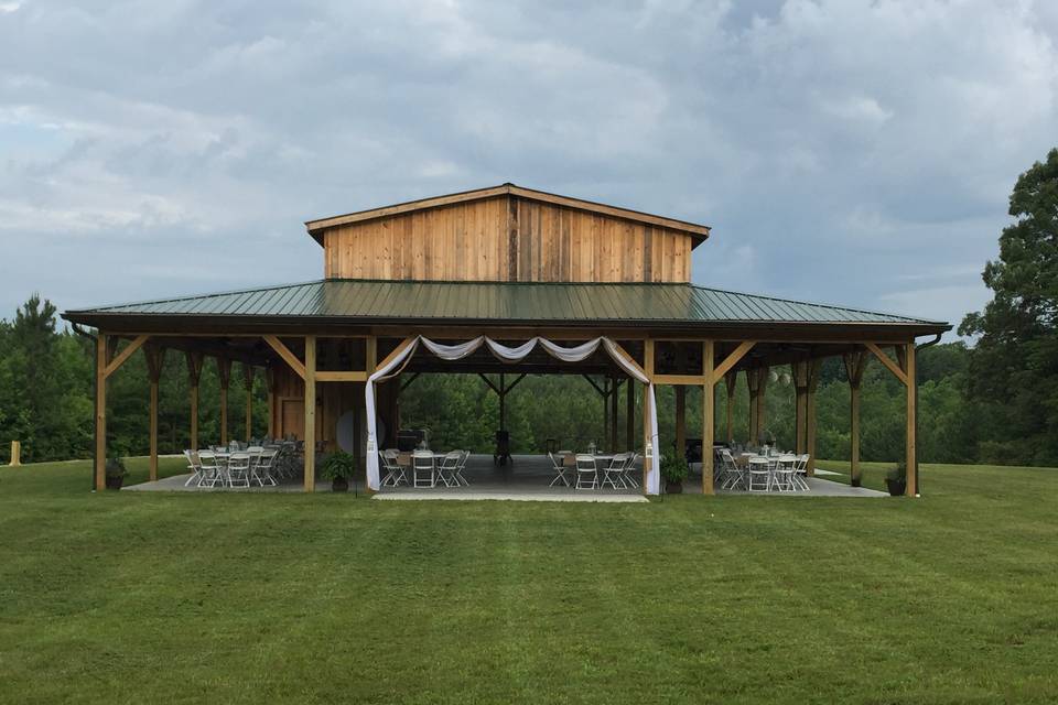 56' X 88' Open Pavilion Barn with Prep Kitchen and Restroom. Chandeliers, Poat Lantern lights and string lights. 16 Ceiling fans.