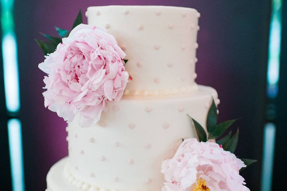 White wedding cake with soft pink flowers