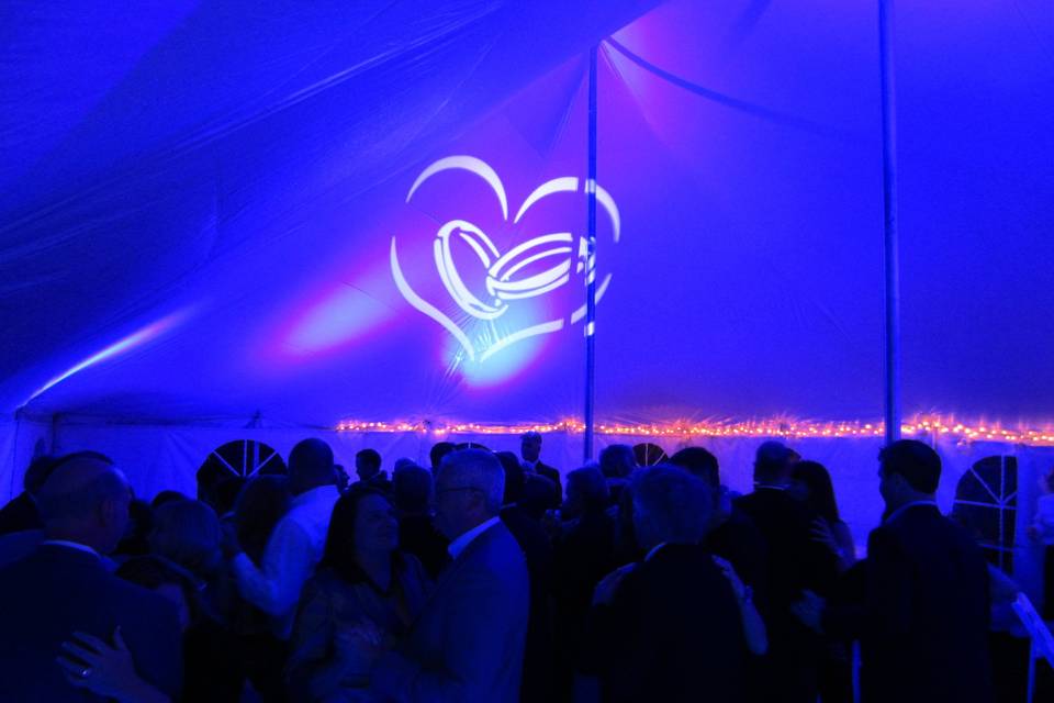 Uplighting and gobo projection on a reception under a tent.  The whole room was bathed in color from the top of the tent.