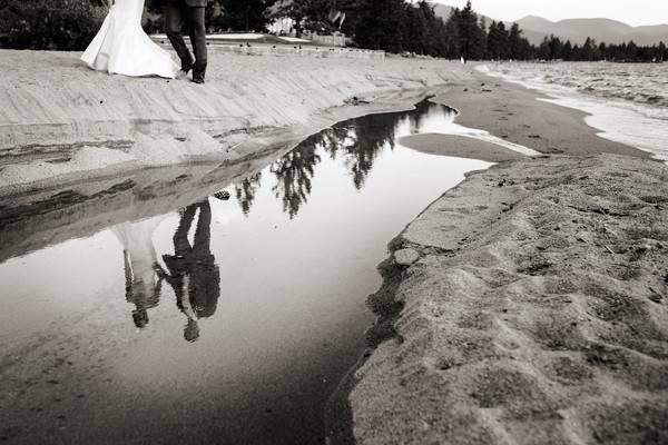 Lake Tahoe bride and groom reflected in a stream at Edgewood