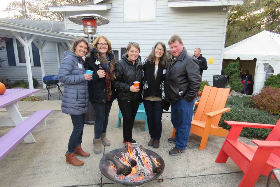 Guests gather around the fire