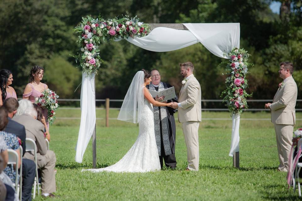 Outdoor ceremony with arch