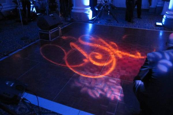 Custom monogram gobo overlaid on a bold, leafy breakup pattern to create a uniqueness on the dance floor