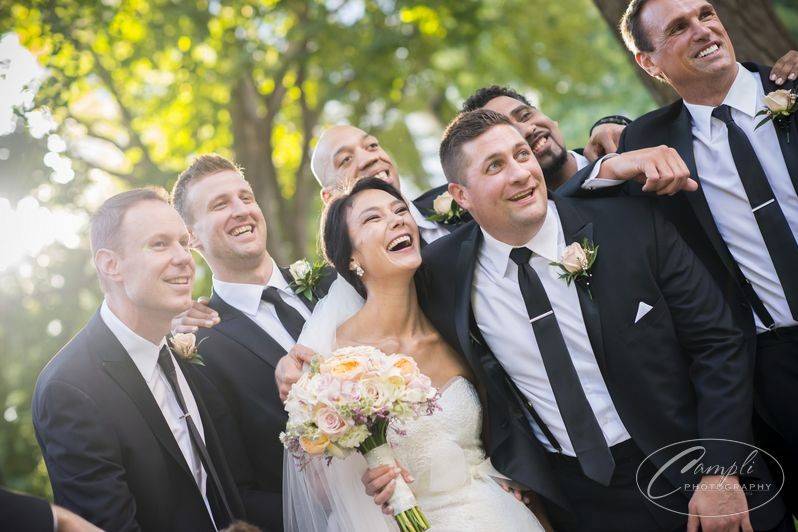 Groom and groomsmen with matching three-piece suits