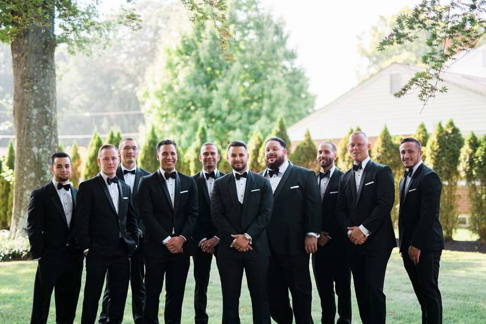 Groom and groomsmen in sharp tuxedos