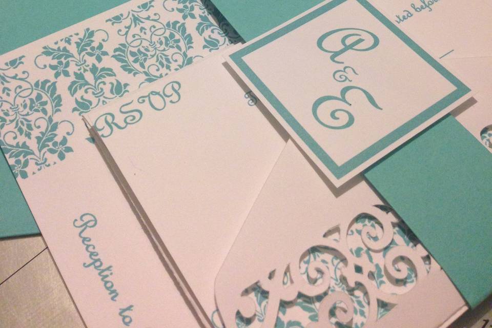 Teal colored invitation with elegant patterns